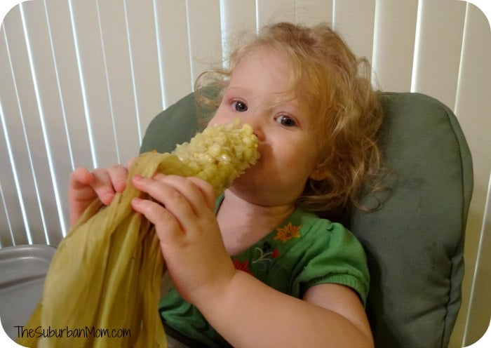 Baby eating corn